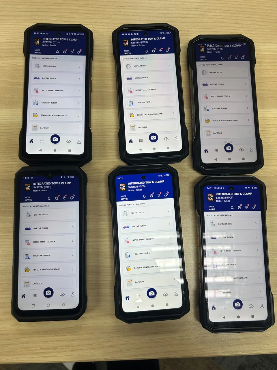 Six rugged handset units with ITCS installed, laid out ready for issue